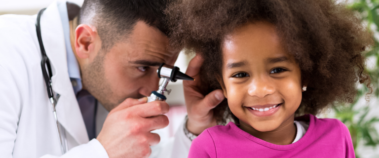 doctor examining a child's ear