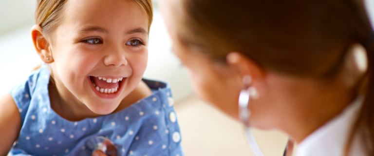 child with open mouth and doctor