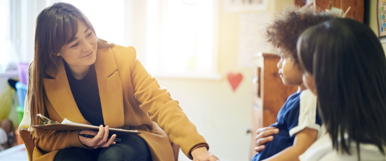 Woman in yellow jacket supporting child and parent